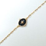 bracelet en acier inoxydable doré avec un pendentif noir orné d'une étoile